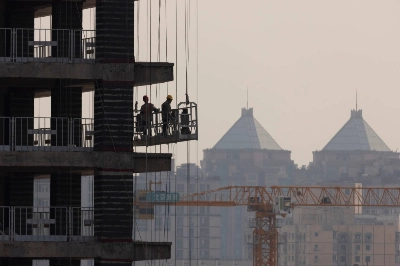 A new high-rise is erected in Beijing in October 2021. The same year, 41% of the assets in China’s banking system were accounted for by property-related loans and credit. A new high-rise is erected in Beijing in October 2021. The same year, 41% of the assets in China’s banking system were accounted for by property-related loans and credit.
