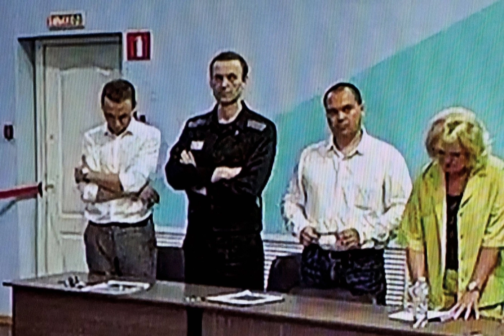Already imprisoned Russian opposition figure Alexei Navalny (second left) listens to his verdict over a series of extremism charges at the IK-6 penal colony, a maximum-security prison some 250 kilometers (155 miles) east of Moscow, on Friday. Already imprisoned Russian opposition figure Alexei Navalny (second left) listens to his verdict over a series of extremism charges at the IK-6 penal colony, a maximum-security prison some 250 kilometers (155 miles) east of Moscow, on Friday.
