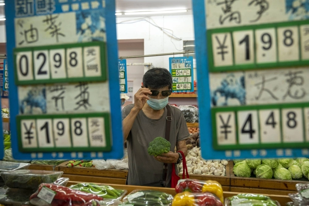 A shopper at a Beijing grocery store in 2022. China's consumer and producer prices have both declined from 12 months ago, indicating that the world’s second-largest economy may be weakening. A shopper at a Beijing grocery store in 2022. China's consumer and producer prices have both declined from 12 months ago, indicating that the world’s second-largest economy may be weakening.