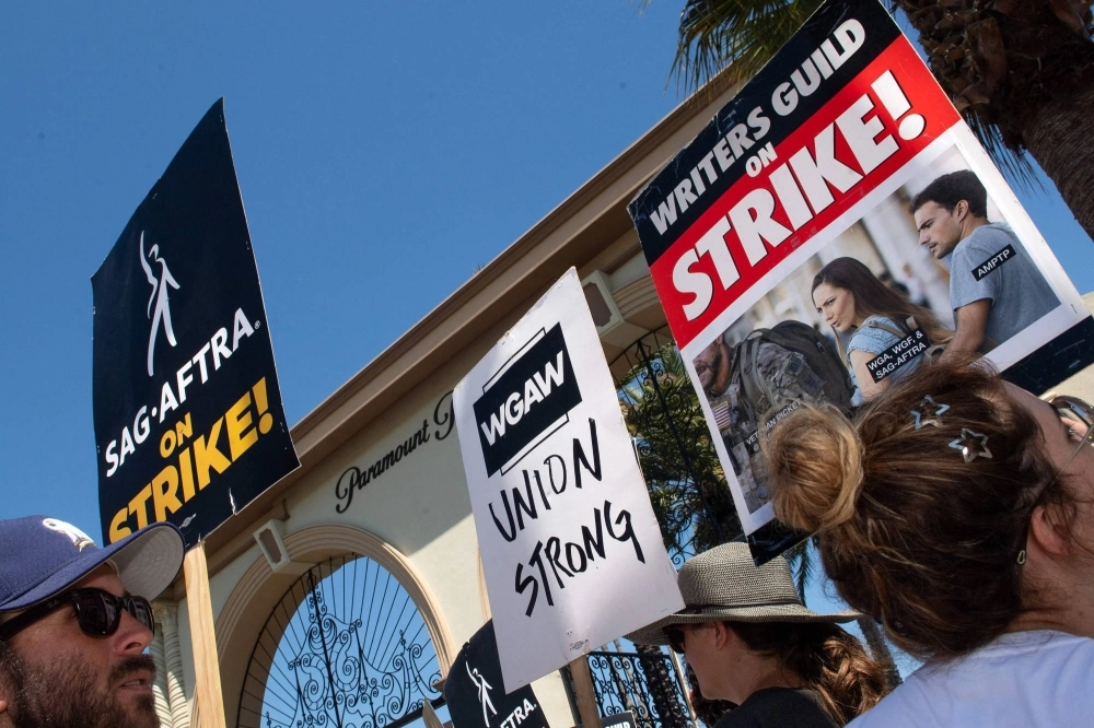 Members of the Writers Guild of America and the Screen Actors Guild-American Federation of Television and Radio Artists walk a picket line outside of Paramount Pictures in Los Angeles. Hollywood actors and writers are currently on strike, effectively bringing the giant movie and television business to a halt in the first industry-wide walkout in 63 years. Members of the Writers Guild of America and the Screen Actors Guild-American Federation of Television and Radio Artists walk a picket line outside of Paramount Pictures in Los Angeles. Hollywood actors and writers are currently on strike, effectively bringing the giant movie and television business to a halt in the first industry-wide walkout in 63 years.