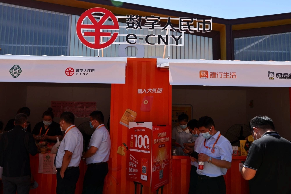 People buy food at stalls promoting China's digital yuan, or e-CNY, during the 2022 China International Fair for Trade in Services in Beijing in September 2022. People buy food at stalls promoting China's digital yuan, or e-CNY, during the 2022 China International Fair for Trade in Services in Beijing in September 2022.