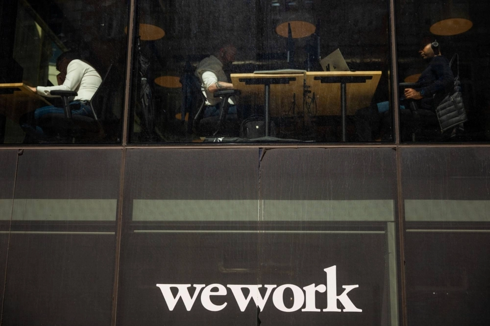 Workers at a WeWork coworking office in London Workers at a WeWork coworking office in London