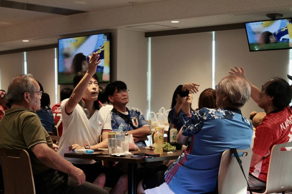 Nadeshiko Japan fans react during a watch party Friday at Saitama Stadium for the team's World Cup quarterfinal.  Nadeshiko Japan fans react during a watch party Friday at Saitama Stadium for the team's World Cup quarterfinal.