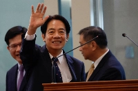 Taiwan's vice president, Lai Ching-te, waves at Taoyuan International Airport before as he departs on Saturday to the United States for a stopover in New York on his way to Paraguay.   | REUTERS