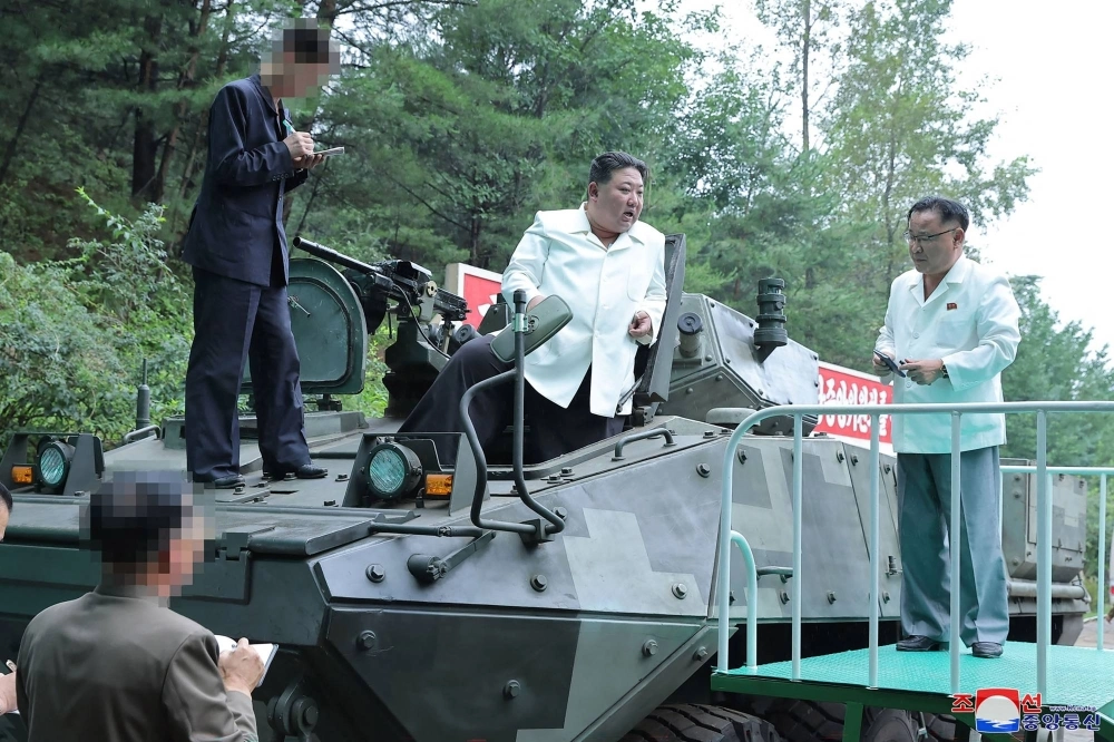 North Korea's leader Kim Jong Un stands on a multipurpose armored vehicle after a visit to an important munitions factory at an undisclosed location in North Korea on Monday. North Korea's leader Kim Jong Un stands on a multipurpose armored vehicle after a visit to an important munitions factory at an undisclosed location in North Korea on Monday.