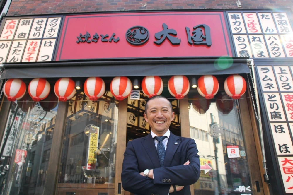 M-Sys President Masao Takikawa stands in front of a Yakiton Daikoku izakaya pub that opened in Sendai's Kokubuncho entertainment district. M-Sys President Masao Takikawa stands in front of a Yakiton Daikoku izakaya pub that opened in Sendai's Kokubuncho entertainment district.
