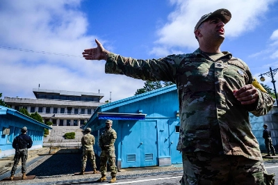 A United Nations Command soldier conducts a media tour of the Demilitarized Zone separating the two Koreas as a South Korean soldier and other UNC soldiers stand guard at the Joint Security Area in the truce village of Panmunjom last October. A United Nations Command soldier conducts a media tour of the Demilitarized Zone separating the two Koreas as a South Korean soldier and other UNC soldiers stand guard at the Joint Security Area in the truce village of Panmunjom last October.