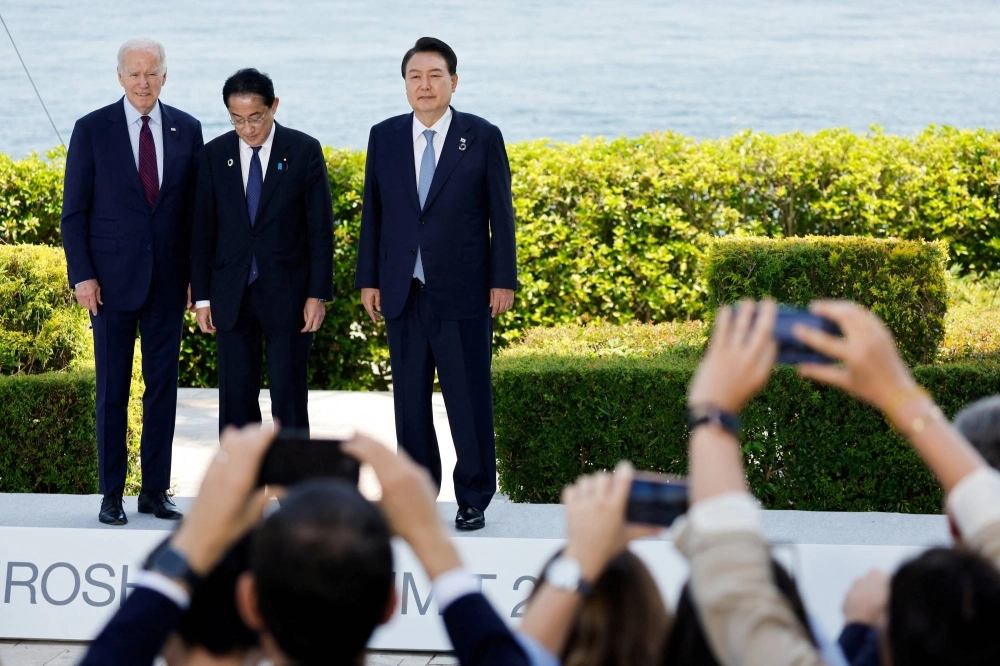 U.S. President Joe Biden, Prime Minister Fumio Kishida and South Korean leader Yoon Suk-yeol attend a photo op on the day of trilateral engagement during the Group of Seven summit at the Grand Prince Hotel in Hiroshima on May 21. U.S. President Joe Biden, Prime Minister Fumio Kishida and South Korean leader Yoon Suk-yeol attend a photo op on the day of trilateral engagement during the Group of Seven summit at the Grand Prince Hotel in Hiroshima on May 21.