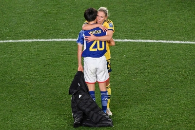 Swedish defender Jonna Andersson (rear) hugs Japan forward Maika Hamano after their World Cup quarterfinal in Auckland on Aug. 11.  Swedish defender Jonna Andersson (rear) hugs Japan forward Maika Hamano after their World Cup quarterfinal in Auckland on Aug. 11.