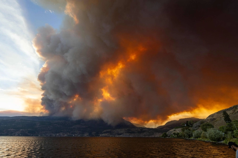 The McDougall Creek wildfire burns in the hills of West Kelowna, British Columbia, on Thursday.  The McDougall Creek wildfire burns in the hills of West Kelowna, British Columbia, on Thursday.