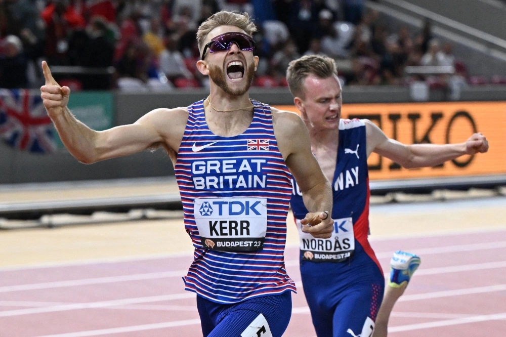 Great Britain's Josh Kerr celebrates as he crosses the finish line to win the men's 1,500-meter final during the World Athletics Championships in Budapest on Thursday. Great Britain's Josh Kerr celebrates as he crosses the finish line to win the men's 1,500-meter final during the World Athletics Championships in Budapest on Thursday.