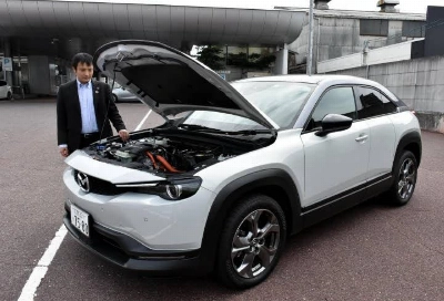 A Mazda MX-30 at a dealership in the city of Hiroshima. The MX-30 is the only electric vehicle model Mazda currently sells in Japan. A Mazda MX-30 at a dealership in the city of Hiroshima. The MX-30 is the only electric vehicle model Mazda currently sells in Japan.