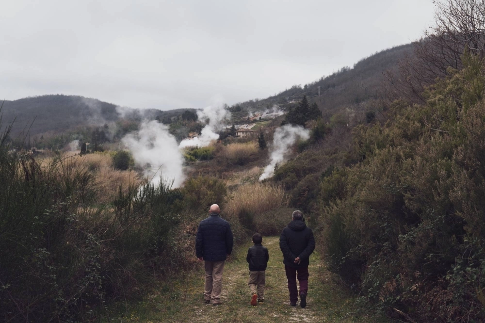 Visitors walk around natural geothermal manifestations at Furmarole park in Sasso Pisano, Italy. Visitors walk around natural geothermal manifestations at Furmarole park in Sasso Pisano, Italy.