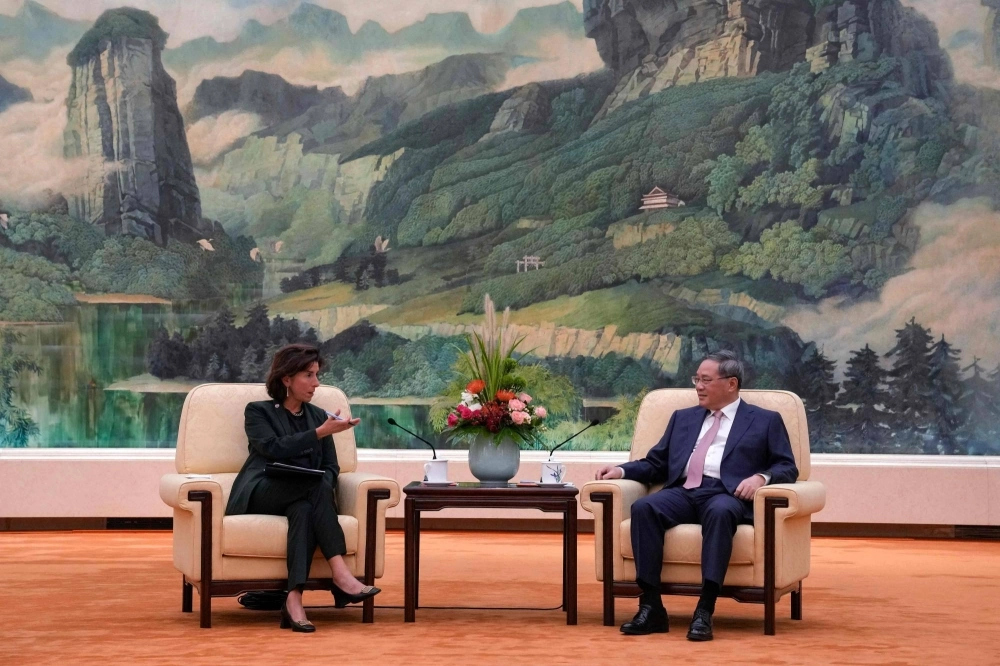 China's Premier Li Qiang (right) speaks with U.S, Commerce Secretary Gina Raimondo during their meeting at the Great Hall of the People in Beijing on Tuesday. China's Premier Li Qiang (right) speaks with U.S, Commerce Secretary Gina Raimondo during their meeting at the Great Hall of the People in Beijing on Tuesday.