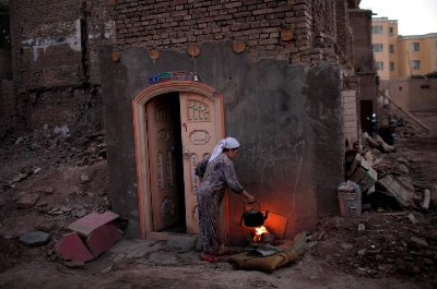 A woman cooks in the old district of Kashgar, in China's Xinjiang region, in 2011. A woman cooks in the old district of Kashgar, in China's Xinjiang region, in 2011.