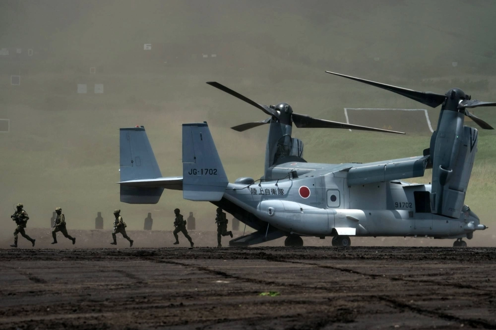 Members of the Ground Self-Defense Force disembark from a V-22 Osprey aircraft during a live-fire exercise in Gotemba, Shizuoka Prefecture, in May 2022. Members of the Ground Self-Defense Force disembark from a V-22 Osprey aircraft during a live-fire exercise in Gotemba, Shizuoka Prefecture, in May 2022.