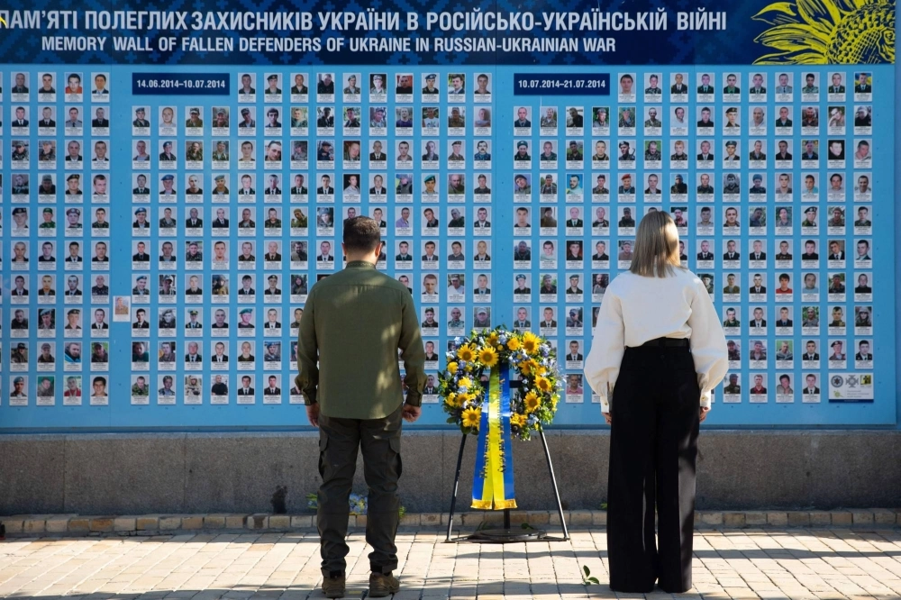 Ukrainian President Volodymyr Zelenskyy and his wife, Olena Zelenska, attend a wreath-laying ceremony at a memorial wall outside of Orthodox Saint Michael's Golden-Domed Monastery during Ukraine's Independence Day celebrations in Kyiv on Aug. 24.  Ukrainian President Volodymyr Zelenskyy and his wife, Olena Zelenska, attend a wreath-laying ceremony at a memorial wall outside of Orthodox Saint Michael's Golden-Domed Monastery during Ukraine's Independence Day celebrations in Kyiv on Aug. 24.