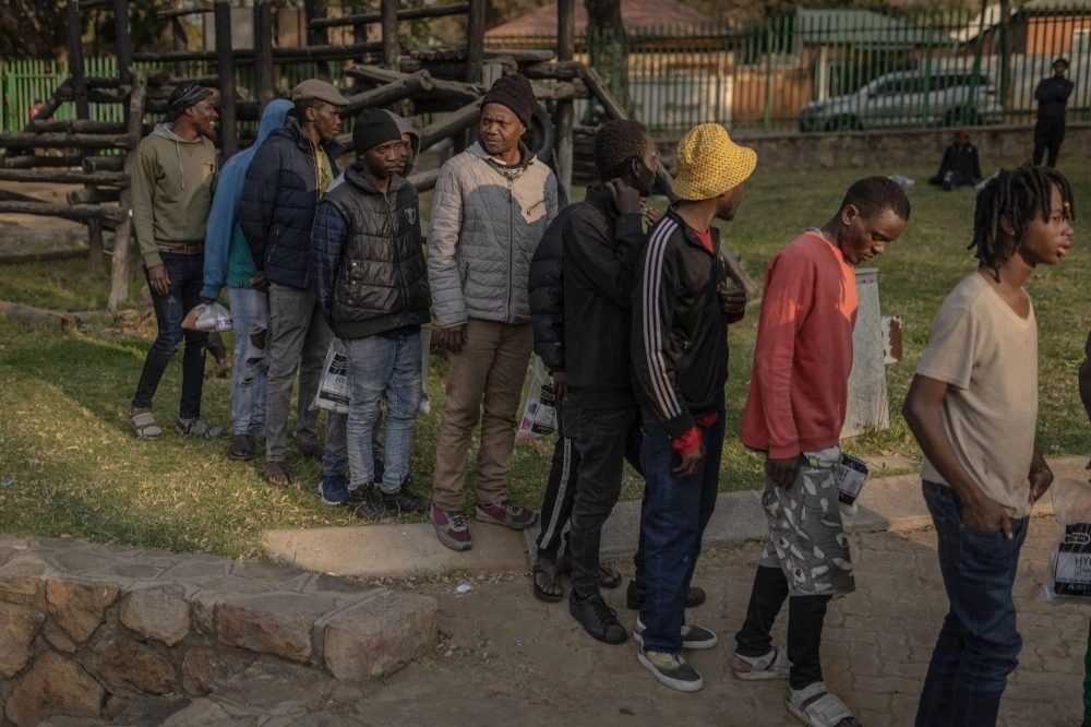 Survivors of the fire that ripped through the five-story building in the early hours on Thursday, killing 74 people, wait in line to receive donated food at a provisional shelter in Johannesburg on Friday. Survivors of the fire that ripped through the five-story building in the early hours on Thursday, killing 74 people, wait in line to receive donated food at a provisional shelter in Johannesburg on Friday.