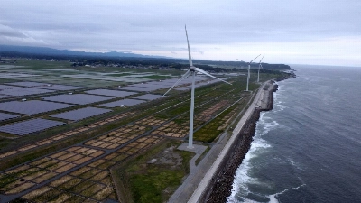 Nestled behind a seawall on the Pacific coast are the Minamisoma Mano-Migita-Ebi solar power plant and the Manyo no Sato wind farm. The 2011 tsunami struck this portion of the coast with a wave that is reported to have been around 18 meters high. Nestled behind a seawall on the Pacific coast are the Minamisoma Mano-Migita-Ebi solar power plant and the Manyo no Sato wind farm. The 2011 tsunami struck this portion of the coast with a wave that is reported to have been around 18 meters high.
