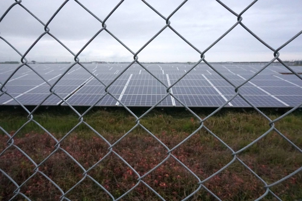 Metal fences and barbed wire surround the Minamisoma Mano-Migita-Ebi solar power plant. Metal fences and barbed wire surround the Minamisoma Mano-Migita-Ebi solar power plant.