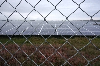 Metal fences and barbed wire surround the Minamisoma Mano-Migita-Ebi solar power plant. | Francesco Bassetti