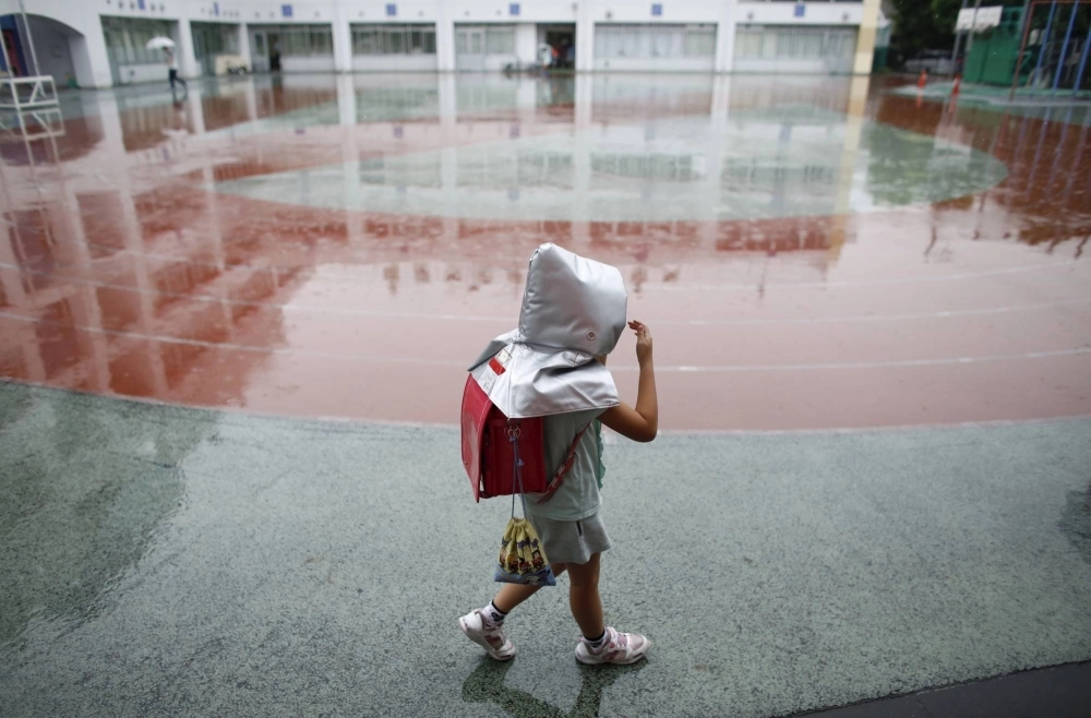 A schoolgirl wears a padded hood for protection from falling debris during an earthquake simulation exercise at an elementary school in Tokyo. The government estimates a 70% chance of a magnitude 7 event striking directly underneath the capital in the next 30 years. A schoolgirl wears a padded hood for protection from falling debris during an earthquake simulation exercise at an elementary school in Tokyo. The government estimates a 70% chance of a magnitude 7 event striking directly underneath the capital in the next 30 years.