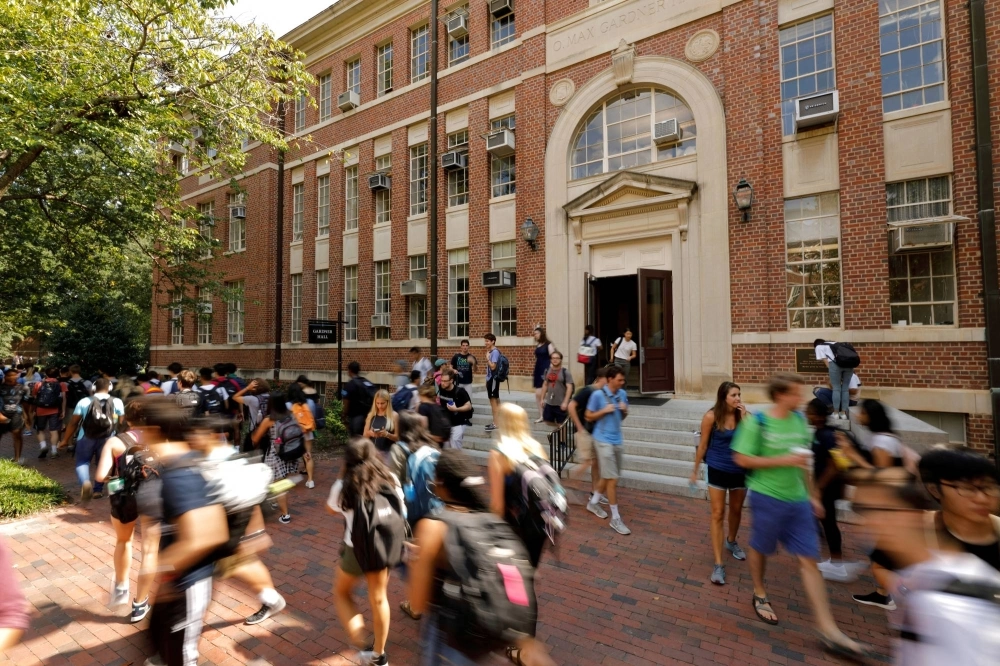 Students walk past a classroom building on the campus of the University of North Carolina at Chapel Hill, North Carolina. Students walk past a classroom building on the campus of the University of North Carolina at Chapel Hill, North Carolina.