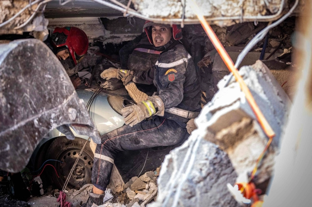 Rescue workers search for survivors in a collapsed house in Moulay Brahim, Morocco, on Saturday after a powerful earthquake hit the country.  Rescue workers search for survivors in a collapsed house in Moulay Brahim, Morocco, on Saturday after a powerful earthquake hit the country.