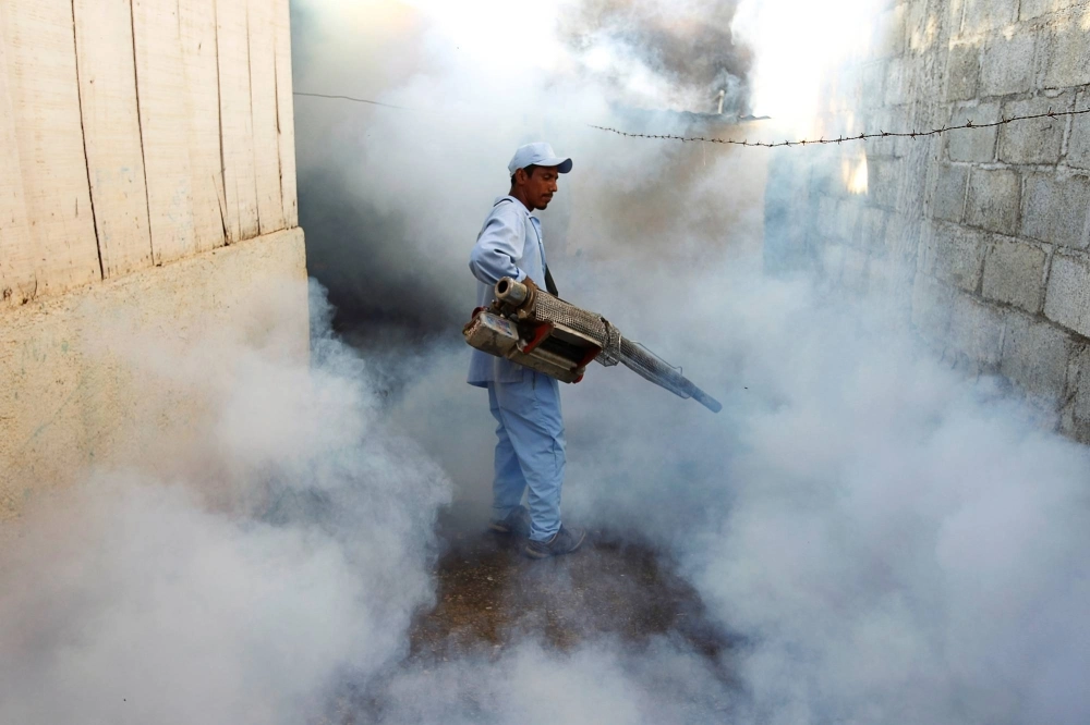 A health ministry worker fumigates a house to kill mosquitoes and curb the spread of dengue, chikungunya and Zika in Managua, Nicaragua. A health ministry worker fumigates a house to kill mosquitoes and curb the spread of dengue, chikungunya and Zika in Managua, Nicaragua.
