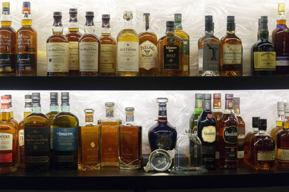 Bottles of whisky sit on display behind the bar at the Door XXV private club in the Golden Equator Group office in Singapore. Bottles of whisky sit on display behind the bar at the Door XXV private club in the Golden Equator Group office in Singapore.