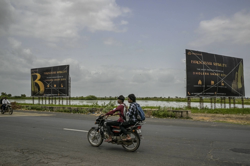 Advertisements for the Dholera Smart City project, which is in the early stages of development, in Dholera, India, on Aug. 25. India’s government, seizing on the world’s desire to reduce reliance on China, is offering billions to build an entire semiconductor ecosystem on vast empty plots. Advertisements for the Dholera Smart City project, which is in the early stages of development, in Dholera, India, on Aug. 25. India’s government, seizing on the world’s desire to reduce reliance on China, is offering billions to build an entire semiconductor ecosystem on vast empty plots.