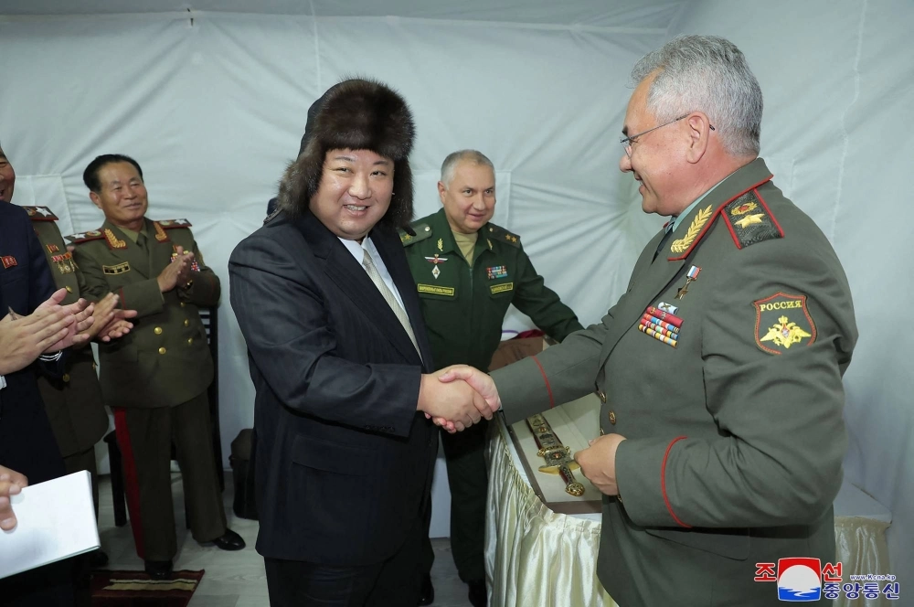 North Korean leader Kim Jong Un shakes hands with Russian Defense Minister Sergei Shoigu after receiving a gift at their luncheon during Kim's visit to the port of Vladivostok, Russia, on Saturday. North Korean leader Kim Jong Un shakes hands with Russian Defense Minister Sergei Shoigu after receiving a gift at their luncheon during Kim's visit to the port of Vladivostok, Russia, on Saturday.
