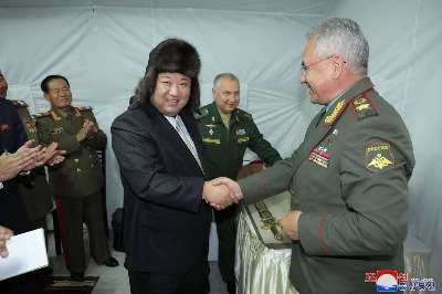 North Korean leader Kim Jong Un shakes hands with Russian Defense Minister Sergei Shoigu after receiving a gift at their luncheon during Kim's visit to the port of Vladivostok, Russia, on Saturday. North Korean leader Kim Jong Un shakes hands with Russian Defense Minister Sergei Shoigu after receiving a gift at their luncheon during Kim's visit to the port of Vladivostok, Russia, on Saturday.