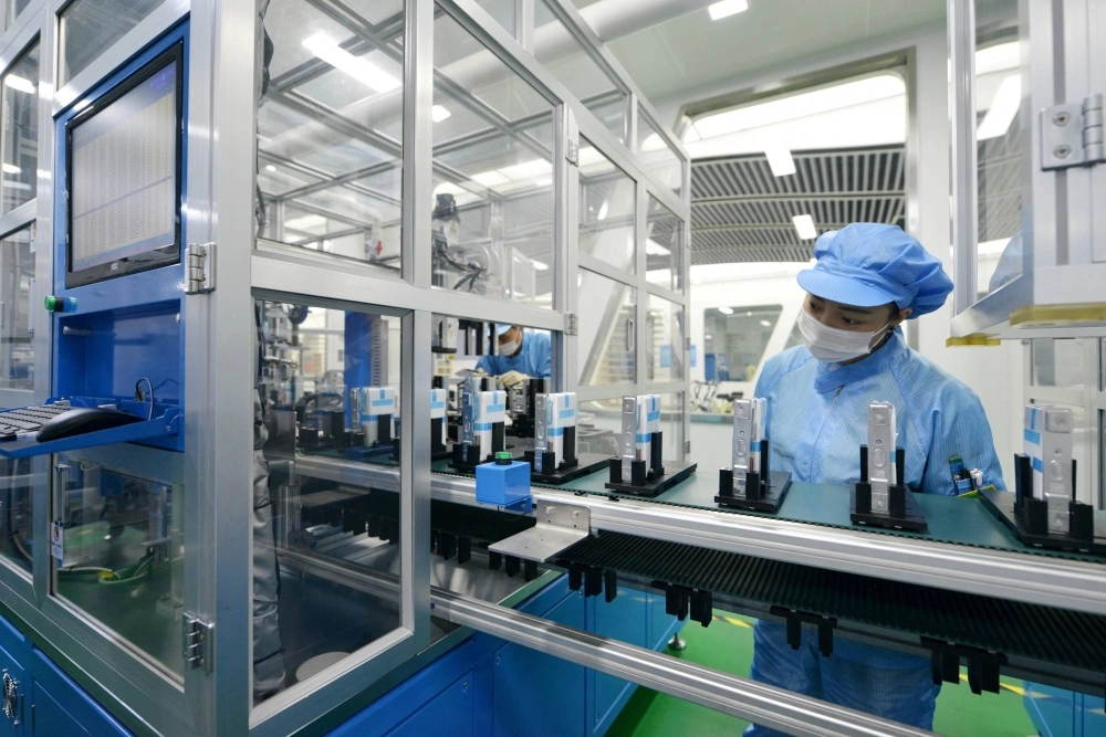 Workers at a production line of lithium-ion batteries for electric vehicles at a factory in Huzhou, Zhejiang province, China Workers at a production line of lithium-ion batteries for electric vehicles at a factory in Huzhou, Zhejiang province, China