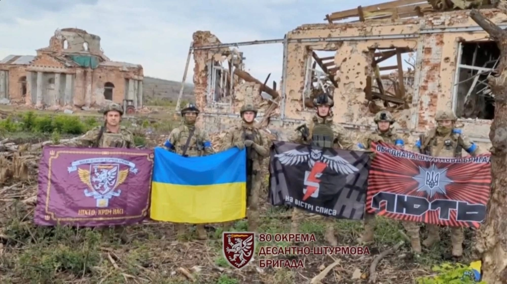 Soldiers hold flags as they speak in front of destroyed buildings in Klishchiivka, Ukraine, in a screen grab taken from a social media video released on Sunday. Soldiers hold flags as they speak in front of destroyed buildings in Klishchiivka, Ukraine, in a screen grab taken from a social media video released on Sunday.