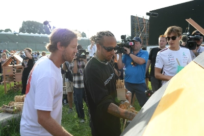 Former Formula One champion Sebastian Vettel (left) helps Lewis Hamilton prepare the Mercedes team's "bee hotel" at Suzuka Circuit in Mie Prefecture on Thursday. Former Formula One champion Sebastian Vettel (left) helps Lewis Hamilton prepare the Mercedes team's "bee hotel" at Suzuka Circuit in Mie Prefecture on Thursday.