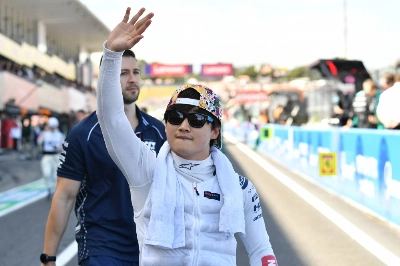 AlphaTauri's Yuki Tsunoda waves to the crowd prior to the start of the Japanese Grand Prix. AlphaTauri's Yuki Tsunoda waves to the crowd prior to the start of the Japanese Grand Prix.