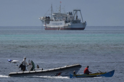 A boat piloted by a Philippine fisherman is intercepted by Chinese coast guard boats as they tried to enter the Scarborough Shoal in disputed waters of the South China Sea. A boat piloted by a Philippine fisherman is intercepted by Chinese coast guard boats as they tried to enter the Scarborough Shoal in disputed waters of the South China Sea.