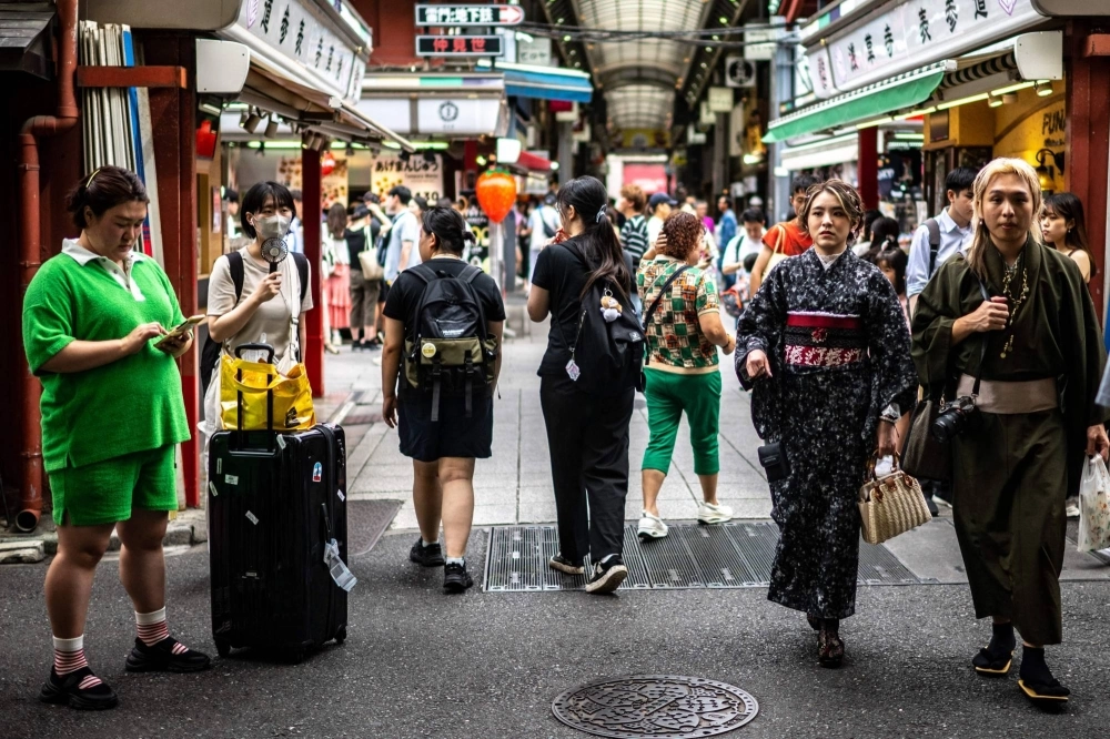 People visit the area near Sensoji Temple, a popular tourist destination, in Tokyo's Asakusa district on Sept. 7. People visit the area near Sensoji Temple, a popular tourist destination, in Tokyo's Asakusa district on Sept. 7.