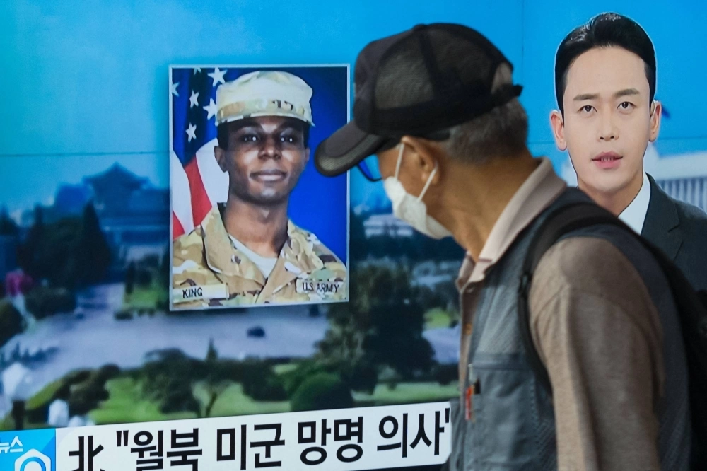 A man walks past a television showing a news broadcast featuring a photo of U.S. soldier Travis King, who ran across the border into North Korea while part of a tour group visiting the Demilitarized Zone on South Korea's border, in Seoul, on Aug. 16. A man walks past a television showing a news broadcast featuring a photo of U.S. soldier Travis King, who ran across the border into North Korea while part of a tour group visiting the Demilitarized Zone on South Korea's border, in Seoul, on Aug. 16.