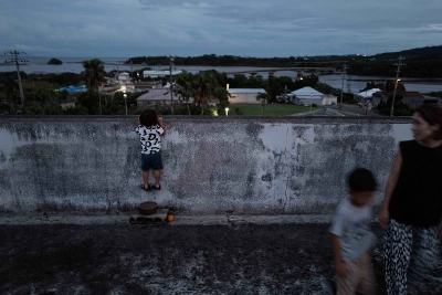 Aoi Suzuki and her two sons head back down to a barbecue after watching the sun set. Aoi Suzuki and her two sons head back down to a barbecue after watching the sun set.