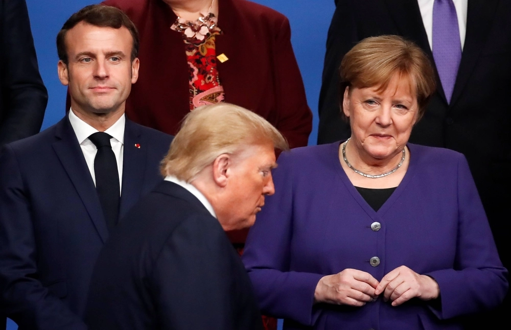 French President Emmanuel Macron, then-German Chancellor Angela Merkel and then-U.S. President Donald Trump during a photo opportunity at a NATO leaders summit in the U.K. in 2019.  French President Emmanuel Macron, then-German Chancellor Angela Merkel and then-U.S. President Donald Trump during a photo opportunity at a NATO leaders summit in the U.K. in 2019.