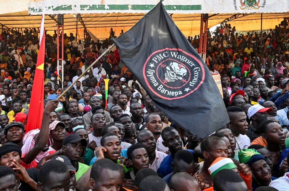 Supporters of Niger's National Council of Safeguard of the Homeland wave a flag of the private Wagner military company during a protest near the capital Niamey on Sept. 16. Supporters of Niger's National Council of Safeguard of the Homeland wave a flag of the private Wagner military company during a protest near the capital Niamey on Sept. 16.