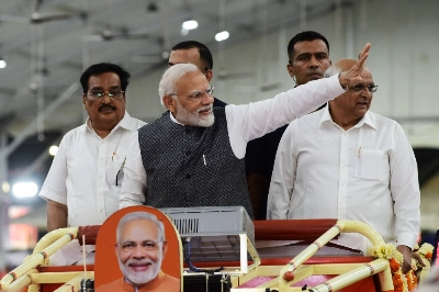 Indian Prime Minister Narendra Modi to the crowd as he arrives at a Bhartiya Janta Party gathering in Ahmedabad on Tuesday.  Indian Prime Minister Narendra Modi to the crowd as he arrives at a Bhartiya Janta Party gathering in Ahmedabad on Tuesday.