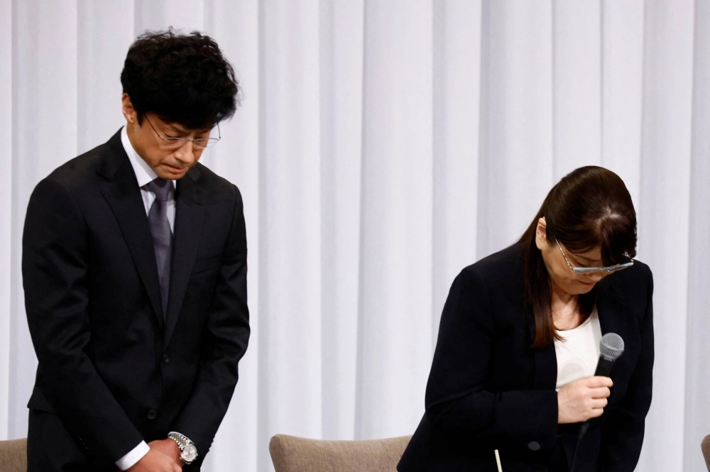 Johnny & Associates' outgoing head Julie Keiko Fujishima and its new chief, Noriyuki Higashiyama, bow to express their apology during a news conference in Tokyo last month.  Johnny & Associates' outgoing head Julie Keiko Fujishima and its new chief, Noriyuki Higashiyama, bow to express their apology during a news conference in Tokyo last month.