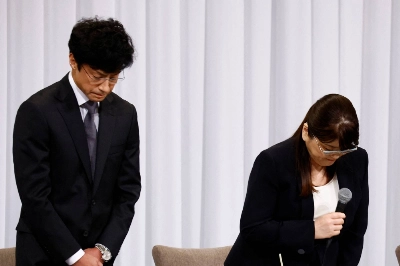 Johnny & Associates' outgoing head Julie Keiko Fujishima and its new chief, Noriyuki Higashiyama, bow to express their apology during a news conference in Tokyo last month.  Johnny & Associates' outgoing head Julie Keiko Fujishima and its new chief, Noriyuki Higashiyama, bow to express their apology during a news conference in Tokyo last month.