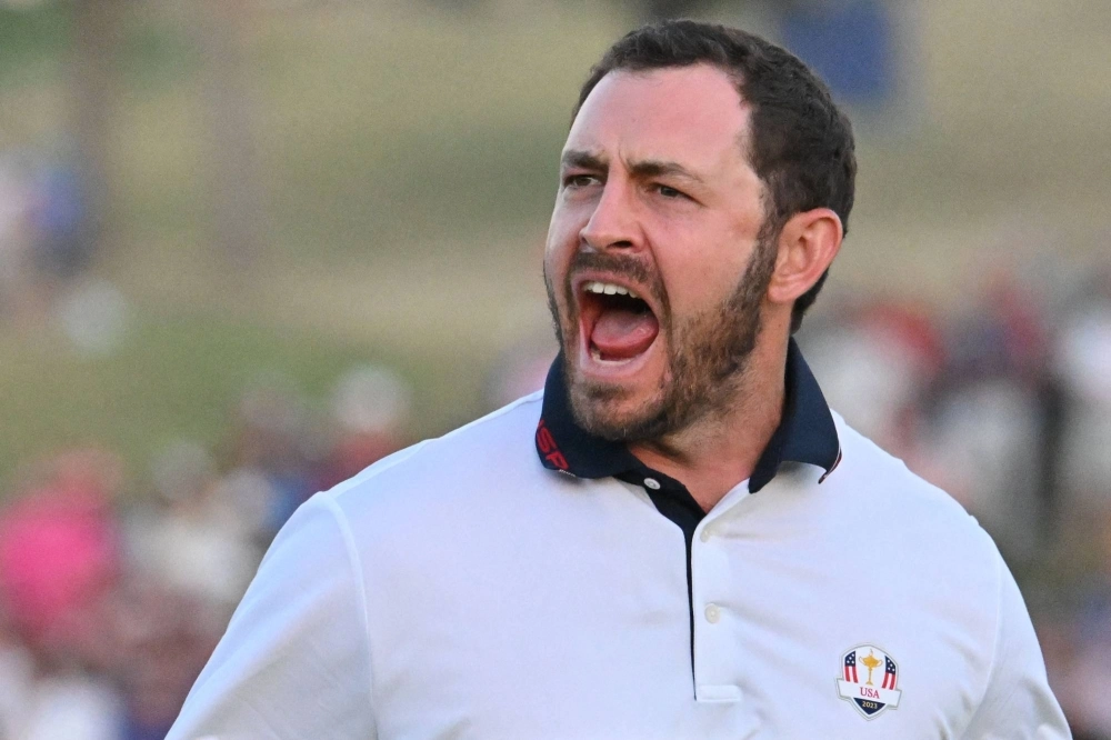 U.S. golfer Patrick Cantlay celebrates after holing his birdie putt on the 18th green to win his fourball match with teammate Wyndham Clark against Team Europe's Rory McIlroy and Matt Fitzpatrick at the Ryder Cup in Rome on Saturday. U.S. golfer Patrick Cantlay celebrates after holing his birdie putt on the 18th green to win his fourball match with teammate Wyndham Clark against Team Europe's Rory McIlroy and Matt Fitzpatrick at the Ryder Cup in Rome on Saturday.