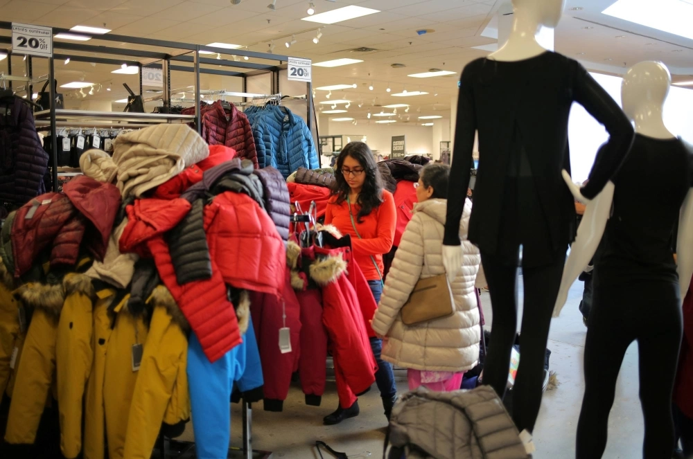 A shopper browses among winter coats at a department store in Mississauga, Ontario, Canada. A shopper browses among winter coats at a department store in Mississauga, Ontario, Canada.