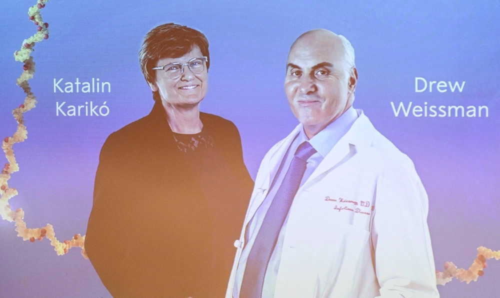 A screen at the Karolinska Institute shows this year's laureates Katalin Kariko of Hungary (left) and Drew Weissman of the U.S. during the announcement of the winners of the Nobel Prize in physiology or medicine. A screen at the Karolinska Institute shows this year's laureates Katalin Kariko of Hungary (left) and Drew Weissman of the U.S. during the announcement of the winners of the Nobel Prize in physiology or medicine.