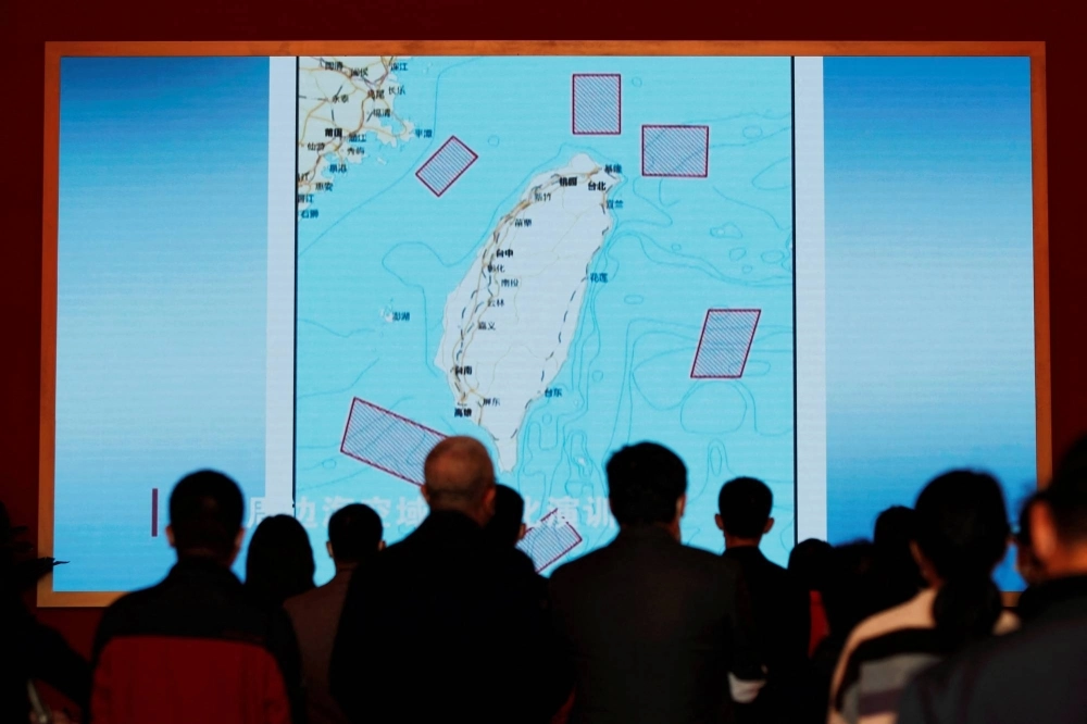 Visitors stand in front of a giant screen displaying a map of locations around Taiwan where the Chinese People's Liberation Army conducted military exercises in August 2022, at an exhibition in Beijing in October last year. Visitors stand in front of a giant screen displaying a map of locations around Taiwan where the Chinese People's Liberation Army conducted military exercises in August 2022, at an exhibition in Beijing in October last year.